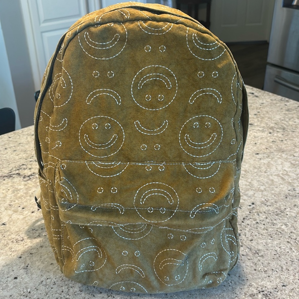 Urban Outfitters embroidered icon backpack. Tan/khaki with smiley faces